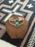sterling silver bracelet cuff with a turquoise center stone and 6 smaller turquoise stones around it